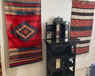 Several Mexican wall hanging and an attractive etagere.