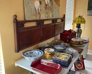 Selection of colorful serving dishes and wood headboard, art by Adair, Vintage Floor lamp with yellow glass shade.