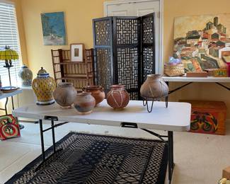 Several large pottery pots are Copper Canyon.  Rug is Bogolan Mud Cloth Fabric. 5 x 5 . Hand made African textile. Three panel screen