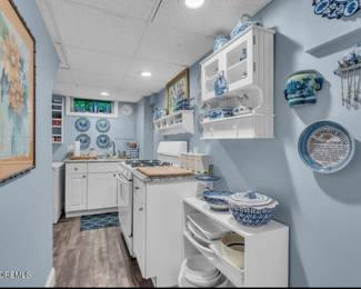 microwave, freezer, white platters, pots, pans, flatware, blie and white plates, artwork for sale
