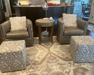 Leather Tufted swivel Barrel chairs and Thomasville ottoman's. Uttermost round table.