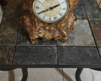Antique clock on iron and tile end table
