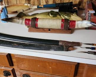 Antique swords, vintage horns and tennis racket