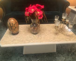Marble like coffee table with Japanese egg, flower arrangement and brass candle