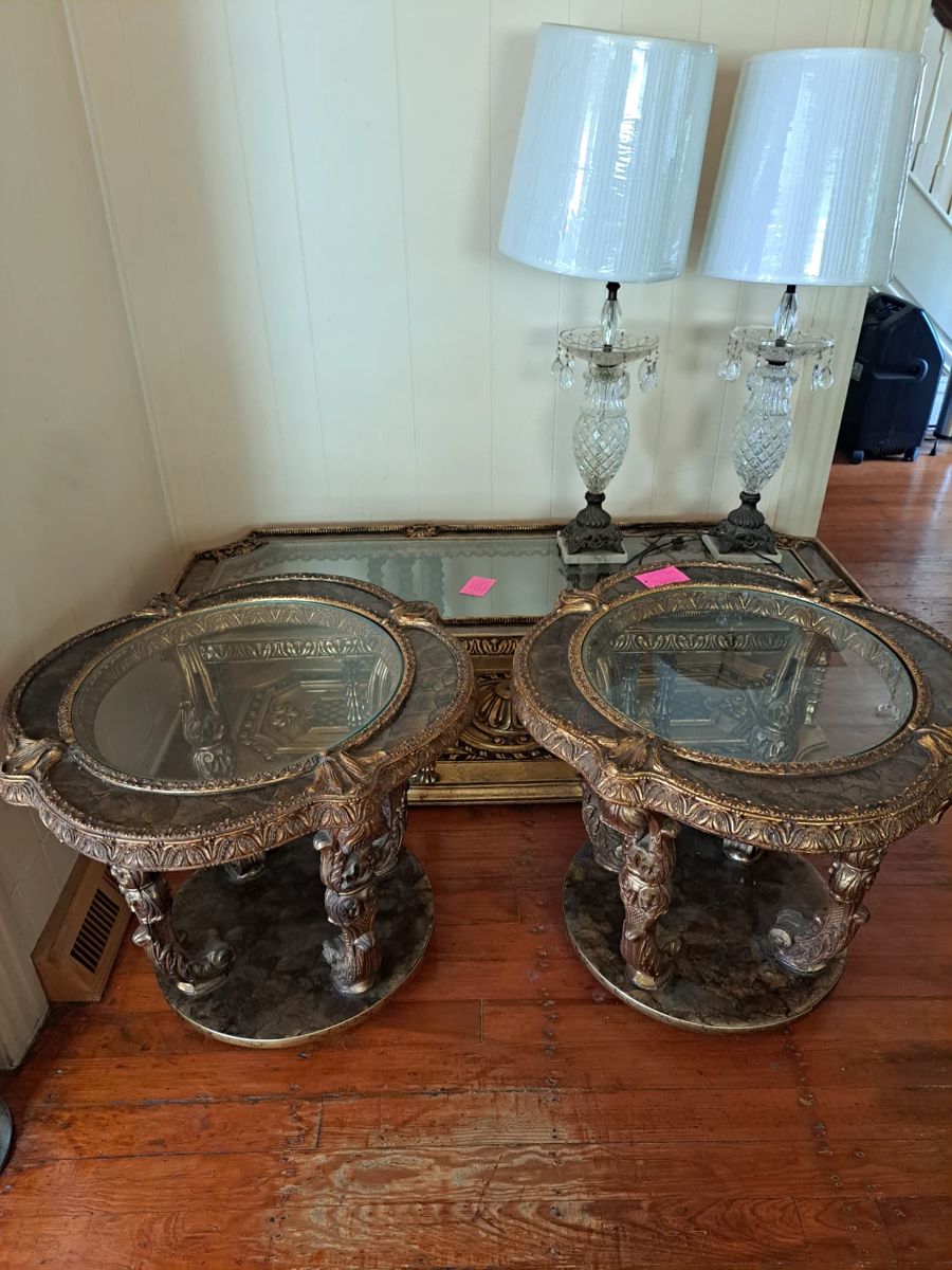 2 antique French ornate table with coffee table. Gold tone embelishments with including decorative carvings and detailed boarder around table tops. 2 vintage cut glass Hollywood Regency style table lamps.