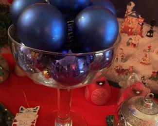 Blue ornaments in oversized champagne glass. Sold as a unit only.