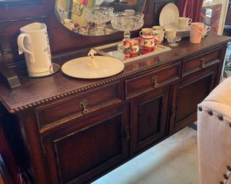 40's time period sideboard. Needs repair on top left where arch connects with frame. It is in good condition.