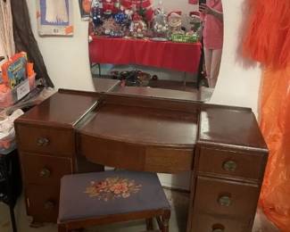 40's style dresser w/ round mirror (another view). In good condition. Holiday decor reflected in mirror.