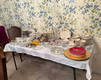 Picture of dining room table with sets of dishes