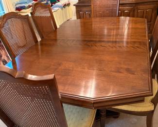 Dining room table with eight chairs, two are captains