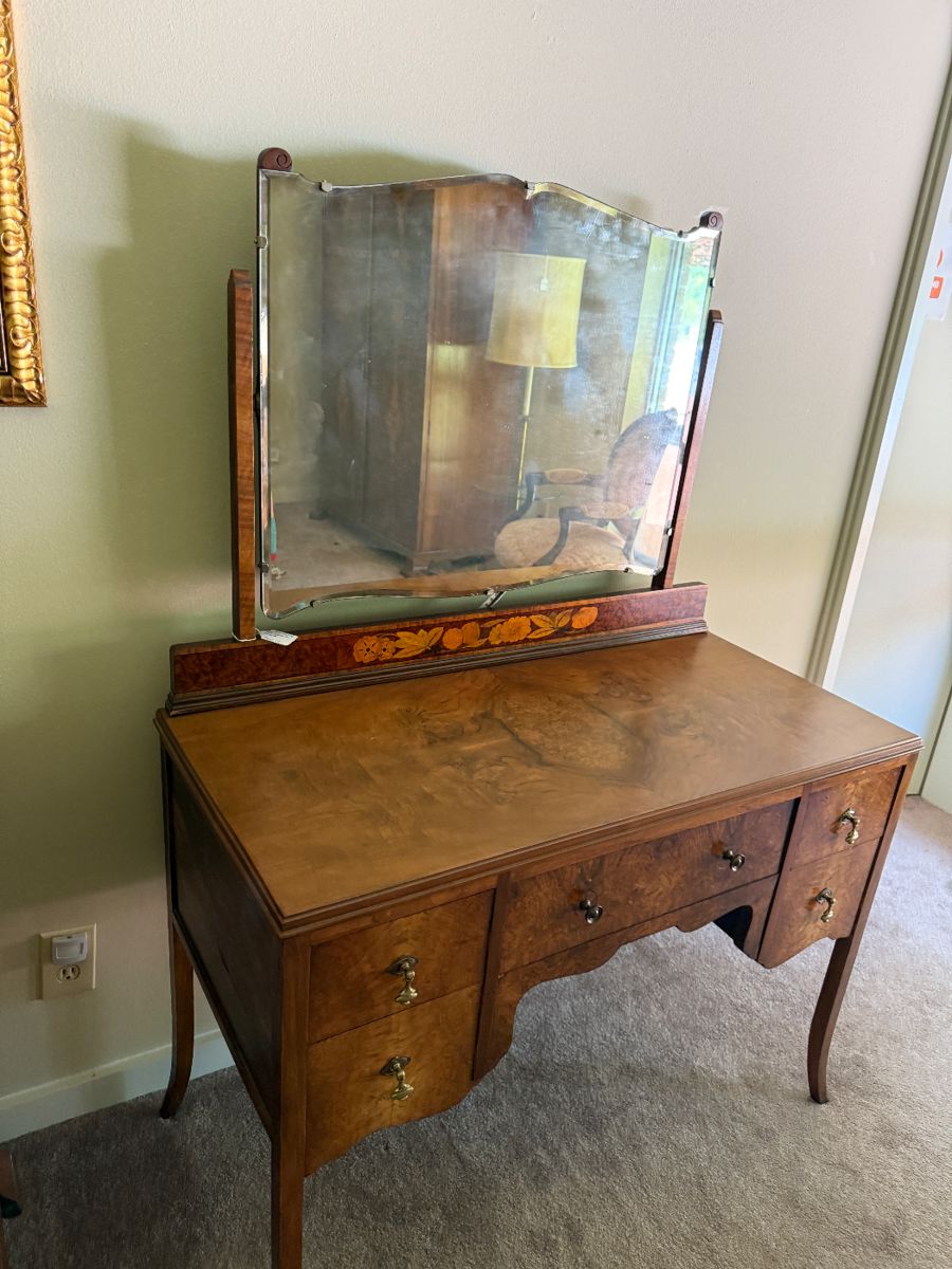 The three pieces that belong to the set are in the bedroom with the two mahogany twin beds