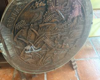 I just love all the carvings. I love all of the furniture that is carved. This tilt top is underneath a glass top.