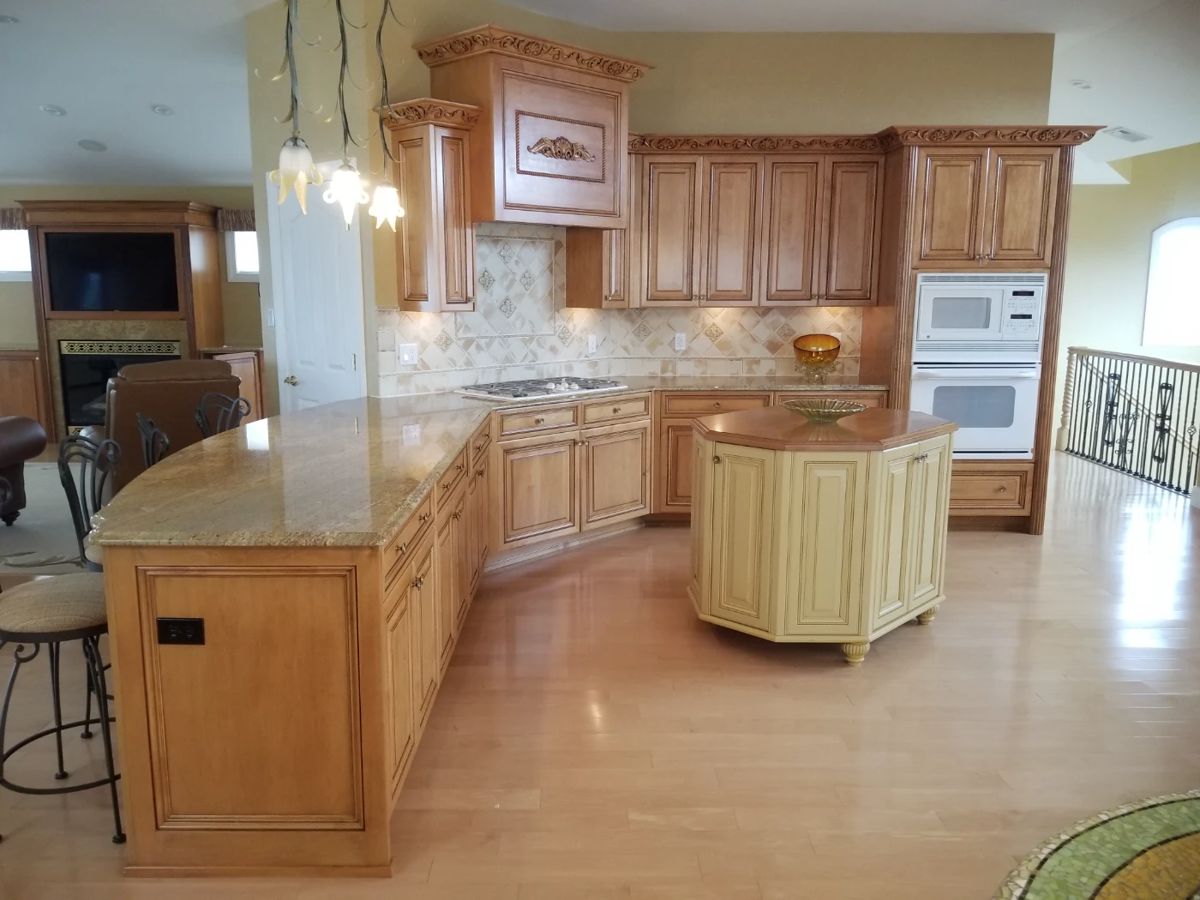 Stunning gourmet kitchen with custom cabinetry & range hood; island
