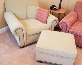 Green arm chair with ottoman detail; accent table
