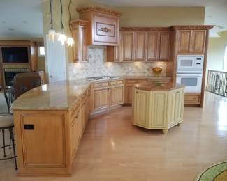 Stunning gourmet kitchen with custom cabinetry & range hood; island
