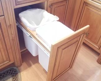 Cabinetry features a trash corral