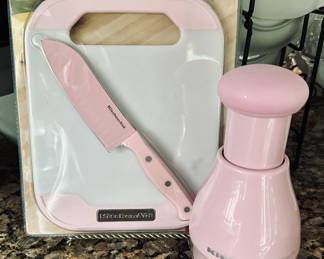 New KitchenAid Two-piece Set Knife and Cutting Board Set Shown With a Matching KitchenAid Manual Hand Food Chopper from the "Cook for the Cure"Line.