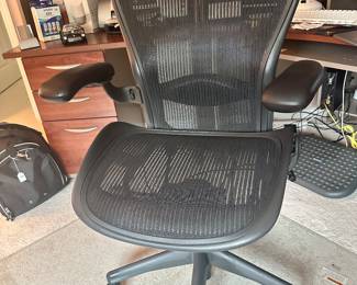 Front View of the Classic Fully Adjustable Herman Miller "Aeron" Posture Fit Office Chair, Size B, Fully Loaded, Shown on a Clearly Innovative Beveled Glass Premium Chairmat, 44" x 50".