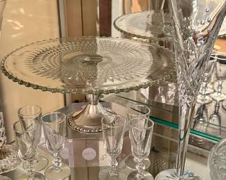 Cut Glass Cake Plate with Sterling Silver Base, Several Sets of Delicate Cordials and a pair of " Millenium" Waterford Champagne Flutes.