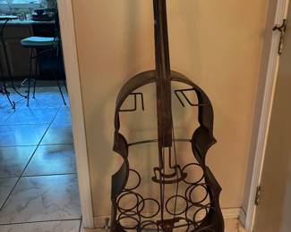 Metal Cello shaped wine holder. 55” tall, 18” wide, 7”deep. $90
