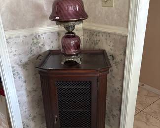 Wine cabinet and purple glass lamp.
