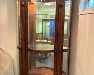 Large curved, carved, lighted display cabinet
