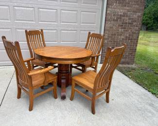 . . . early 1900's oak pedestal table with four matching oak chairs
