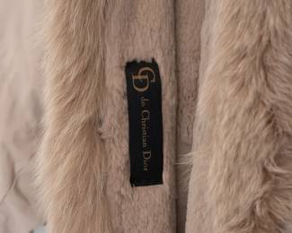 Closeup of the vintage Christian Dior fur lined belted long coat with fur shawl collar and trim