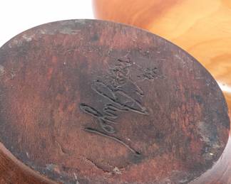 Closeup of the burled turned wood vase signed by the artist