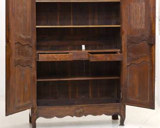 Another view of the French 19th Century carved wooden two door cupboard or armoire with internal shelving and two drawers