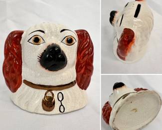 Antique Staffordshire style ceramic coin bank in the form of a King Charles Cavalier Spaniel dog with red ears, gold eyes, and wearing a collar.