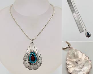 Native American style signed sterling silver pendant set with turquoise and coral on a 24" sterling silver chain.