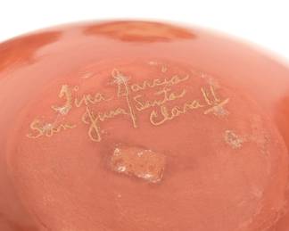 Closeup of the Tina Garcia Santa Clara Pueblo redware jar with bear paw design