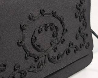 Closeup of Givenchy Paris vintage black satin embroidered shoulder bag