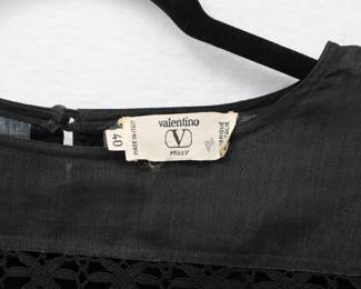 Closeup of Valentino black long sleeved lace insert top and skirt set, size 40, made in Italy