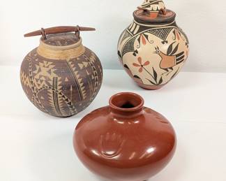 Native American art pottery including a traditional Zia Pueblo jar with turtle lid by Elizabeth Medina, and a Tina Garcia Santa Clara Pueblo redware jar with bear paw design
