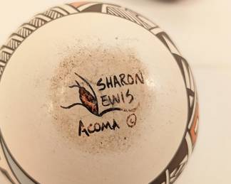 Closeup of hand painted Acoma Pueblo pottery jars with three-dimensional buttery fly and turtle lids, signed by potter Sharon Lewis