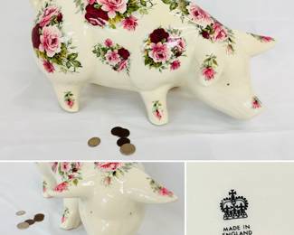 A charming and large porcelain piggy bank, made in England; cream color body decorated with colorful sprays of pink and red roses