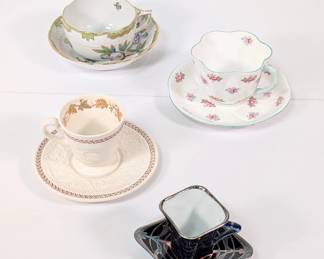 A Herend porcelain hand painted cup and saucer, a Shelley England Fine Bone China cup and saucer with roses pattern, a Wedgwood Patrician Golden Ivy pattern cup and saucer, and a Victoria Austria porcelain cup and saucer