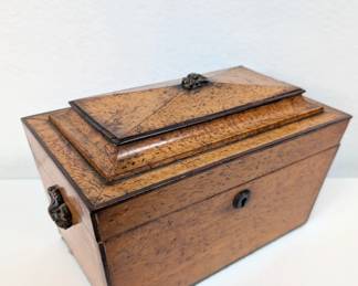 Early 19th century tea caddy, a coffer form birds eye maple veneered caddy with divided interior