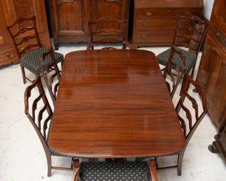A wonderful mahogany dining table with leaves, along with eight mahogany ladder back dining chairs
