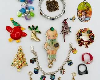 A playful assortment of vintage and contemporary costume jewelry including an Italian cities charm bracelet and a nice selection of Christmas holiday brooches