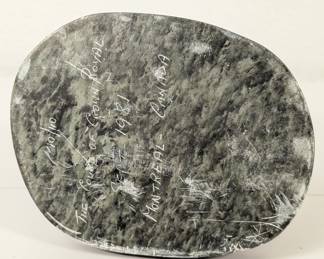 Underside of base of the vintage stone sculpture of Inuit eskimo cleaning fish