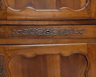 An antique wooden two-door cupboard with locking center drawer (with key)