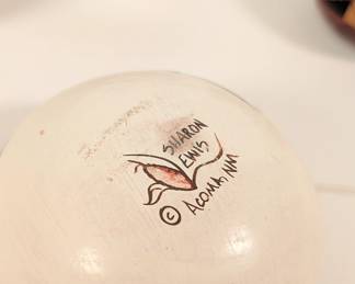 Closeup of hand painted Acoma Pueblo pottery jars with three-dimensional buttery fly and turtle lids, signed by potter Sharon Lewis