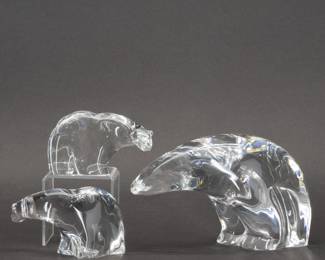 Group of Three Steuben Glass Polar Bears. A beautiful set of three hand formed glass polar bears, each with Steuben’s distinctive visual and tactile artistry, each signed Steuben on the base. Large bear is 7-3/4 inches L x 4-3/4 inches H, the two smaller bears are 4-1/2 inches L x 2-1/2 inches H.