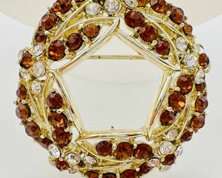Closeup of one of the sparkly brooches with warm cognac color and clear crystals