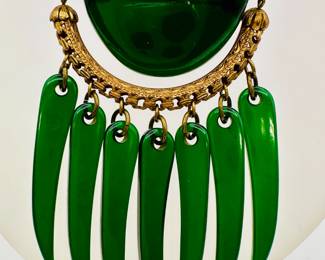 A dramatic and rare vintage green Bakelite and gold tone brooch, slender curved bear claw dangles