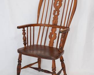 One of three antique mid 19th century English broad arm Windsor chairs