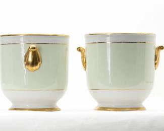 A pair of small porcelain cache pots, white and pale green with applied gold gilt enamel